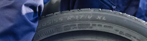 Close-up of a tyre sidewall showing the XL extra load marking next to the 205/55 R17 V size code