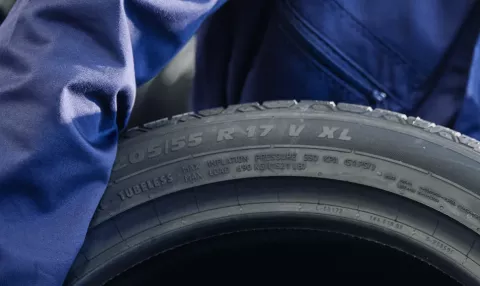 Close-up of a tyre sidewall showing the XL extra load marking next to the 205/55 R17 V size code