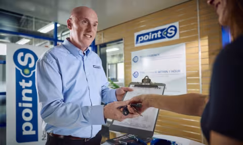 A Point S workshop manager showing MOT test results to a customer